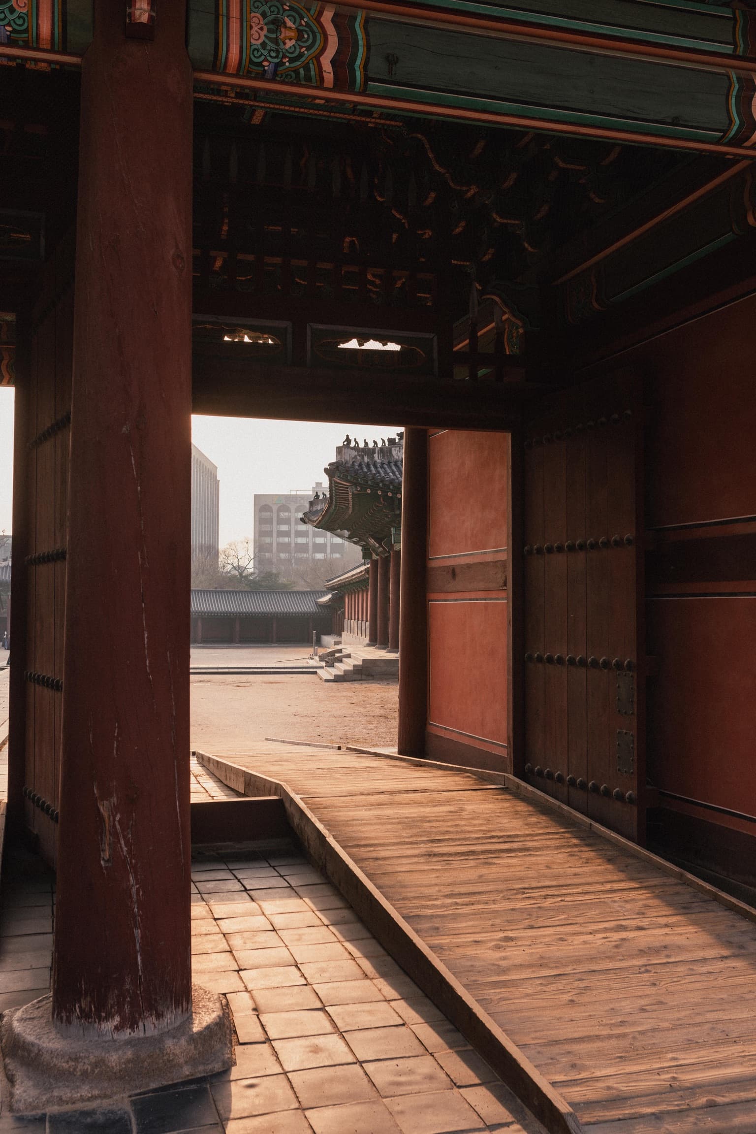Looking through a red wooden palace gate