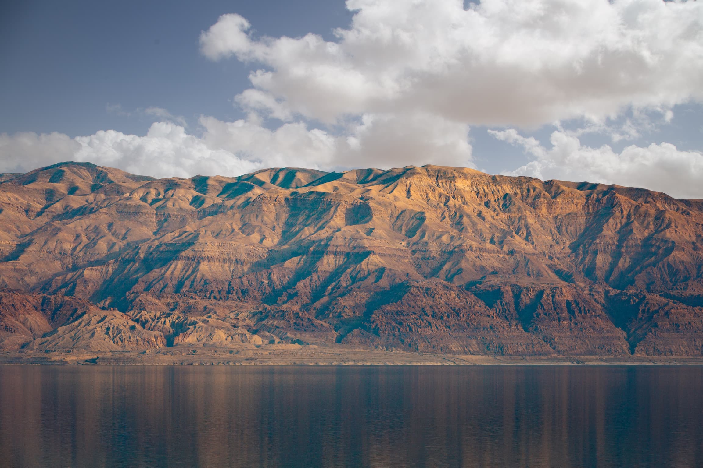 Red mountains above a still lake